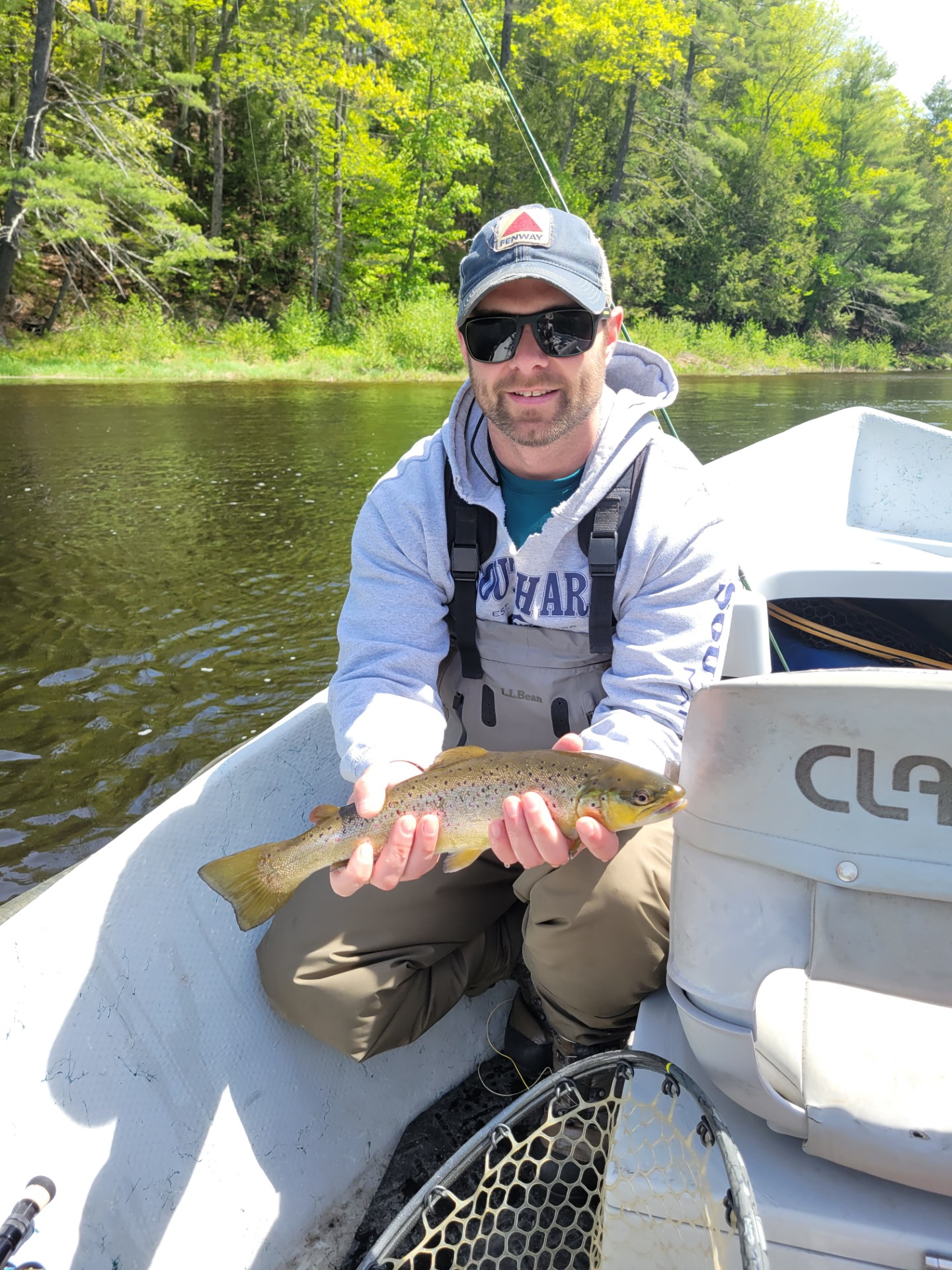 Man in boat holding a fish