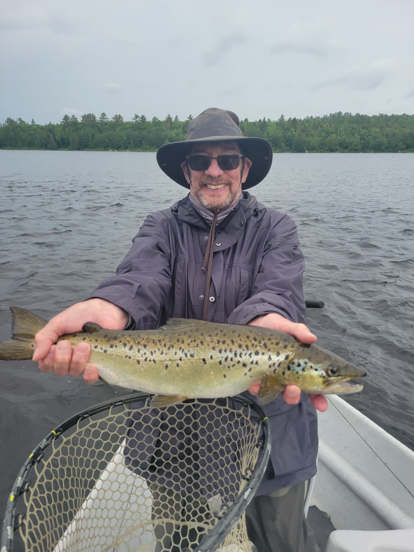 Man with large smile holding fresh caught fish
